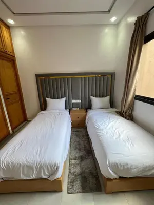 two beds sitting next to each other in a room at Villa JADE with private pool only family in Marrakech