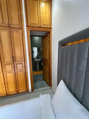 a bedroom with a bed and a bathroom with a sink at Villa JADE with private pool only family in Marrakech