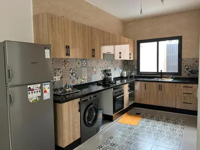 a kitchen with a refrigerator and a dishwasher at Villa JADE with private pool only family in Marrakech