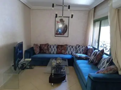 a living room with a blue couch and a tv at Modern 2 Bedroom Appartement in Gueliz in Marrakech