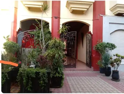 an entrance to a house with a red gate and plants at Modern 2 Bedroom Appartement in Gueliz in Marrakech