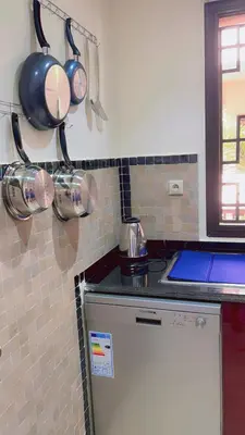 a kitchen with pots and pans hanging on the wall at Ben House Palmeraie in Marrakech