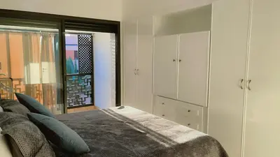 a bedroom with a bed and a large window at Ben House Palmeraie in Marrakech