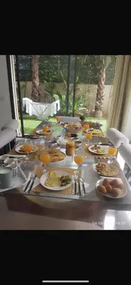 a table filled with plates of food and orange juice at Villa spacieuse à Marrakech avec piscine privée_222 in Marrakech