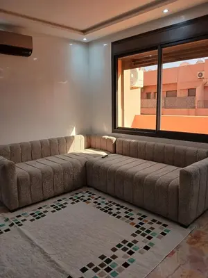 a living room with a couch and a window at Cosy appartement Victor Hugo in Marrakech