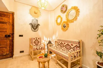 a room with two chairs and a table and mirrors at Dar mehdi in Marrakech