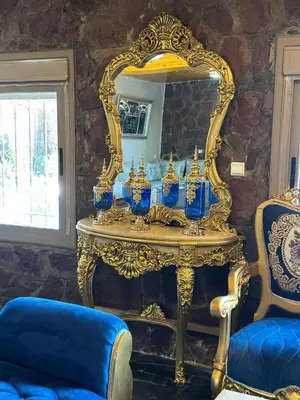 a gold table with blue vases in front of a mirror at villa ourika in Marrakech