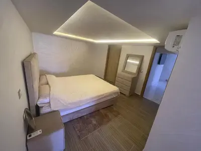 a small bedroom with a bed and a mirror at Appartement downtown marrakech in Marrakech