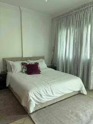 a bed with white sheets and pillows in a bedroom at Elegant appartement a Gueliz in Marrakech