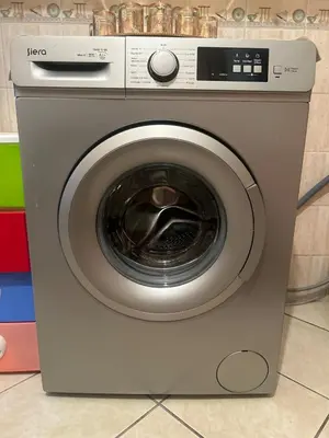 a dryer with a washing machine in a room at Elegant appartement a Gueliz in Marrakech