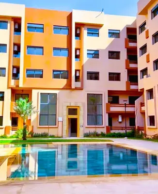 an apartment building with a swimming pool in front of it at New apartment with pool in Marrakech