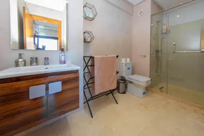 a bathroom with a sink and a shower and a toilet at New apartment with pool in Marrakech