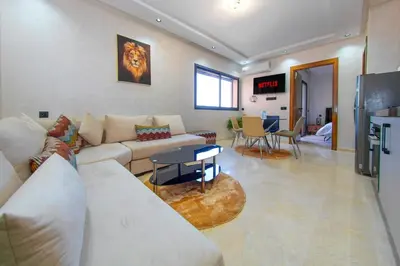 a living room with a couch and a table at New apartment with pool in Marrakech