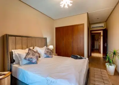 a bedroom with a large white bed with pillows at luxury, 4 pools et golf in prestigious in Marrakech