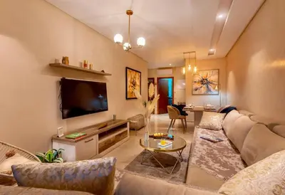 a living room with a couch and a flat screen tv at luxury, 4 pools et golf in prestigious in Marrakech