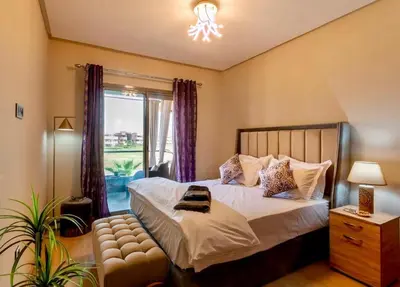 a bedroom with a bed and a window at luxury, 4 pools et golf in prestigious in Marrakech