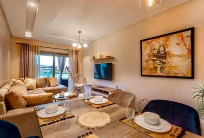 a living room with a table and a couch at luxury, 4 pools et golf in prestigious in Marrakech