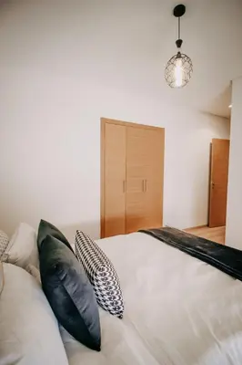 a bedroom with a bed with pillows on it at Spacious 3BR with Prime Location in Marrakech