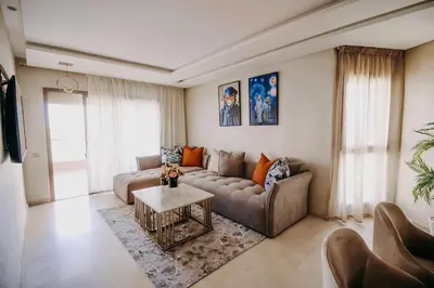 a living room with a couch and a table at Spacious 3BR with Prime Location in Marrakech