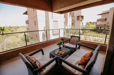 a balcony with a table and chairs on a balcony at Spacious 3BR with Prime Location in Marrakech