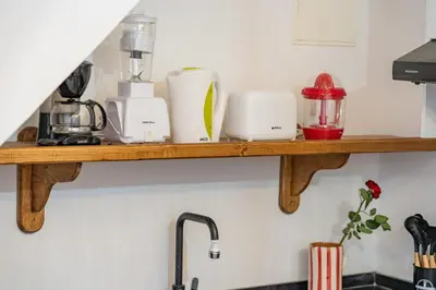 a shelf above a kitchen counter with appliances on it at Riad privatif 2 Chambres, Jacuzzi Proche des Palais in Marrakech