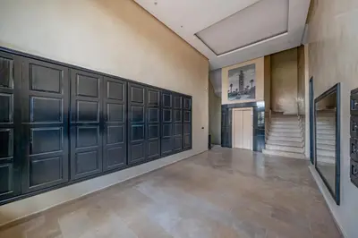 a hallway with lockers and a staircase in a building at Le Darna - Marrakech Victor Hugo - 2prs - Wifi in Marrakech