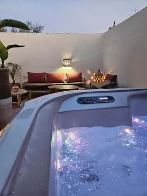 a swimming pool with a hot tub in a backyard at RIAD AWEL - 3 chambres & jacuzzi au coeur de la Medina in Marrakech