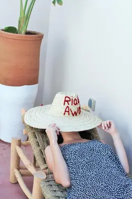 a young child wearing a hat with the words rxawi at RIAD AWEL - 3 chambres & jacuzzi au coeur de la Medina in Marrakech