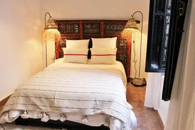 a bedroom with a large bed with two pillows at RIAD AWEL - 3 chambres & jacuzzi au coeur de la Medina in Marrakech