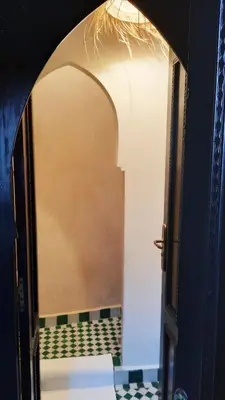 an open door to a bathroom with a mirror at RIAD AWEL - 3 chambres & jacuzzi au coeur de la Medina in Marrakech