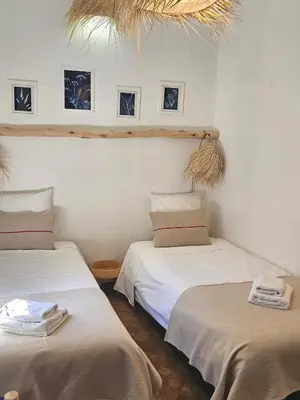two beds sitting next to each other in a room at RIAD AWEL - 3 chambres & jacuzzi au coeur de la Medina in Marrakech