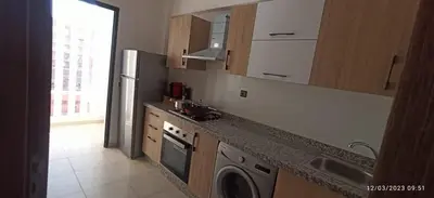 a kitchen with a washing machine and a sink at Magnifique appartement avec piscine à Gueliz in Marrakech