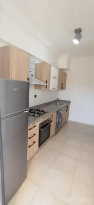 a kitchen with a stainless steel refrigerator and stove at Magnifique appartement avec piscine à Gueliz in Marrakech