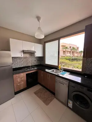 a kitchen with a sink and a dishwasher at Prestigia Argane Jubaea Marrakech in Marrakech