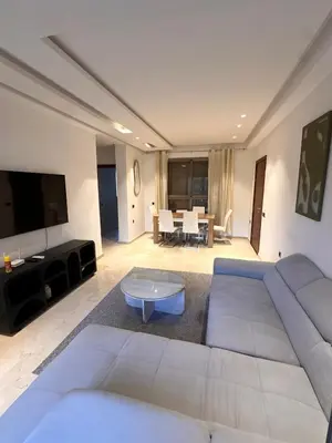 a living room with a couch and a table at Prestigia Argane Jubaea Marrakech in Marrakech
