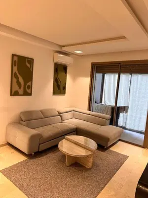 a living room with a couch and a coffee table at Prestigia Argane Jubaea Marrakech in Marrakech