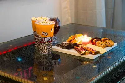 a table with a drink and a plate of cookies and a candle at Appartement Moderne à Marrakech in Marrakech