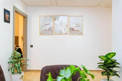 a living room with three pictures on the wall at Appartement Moderne à Marrakech in Marrakech