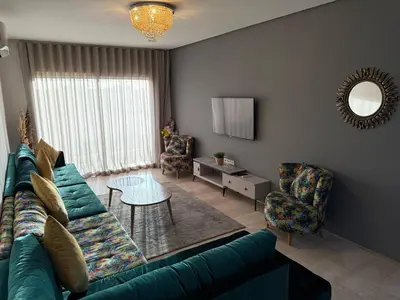 a living room with a couch and a table at Appartemen luxe in Marrakech