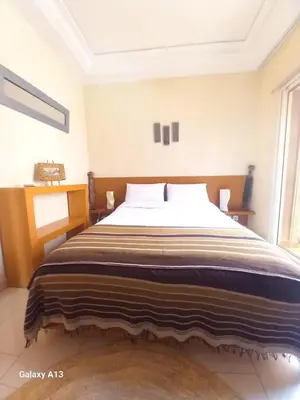 a bedroom with a large bed in a room at Cosy et confortable in Marrakech