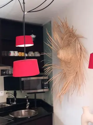 a kitchen with two red lights and a sink at Cosy et confortable in Marrakech