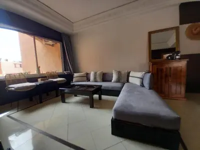 a living room with a couch and a table at Cosy et confortable in Marrakech