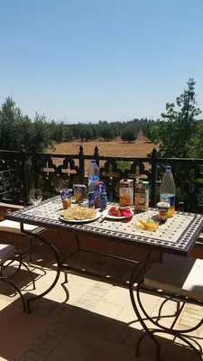 a picnic table with food and drinks on a patio at Atlas resort, 3 pools, roof terrace, holiday home in Marrakech