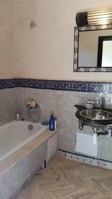 a bathroom with a bath tub and a sink at Atlas resort, 3 pools, roof terrace, holiday home in Marrakech