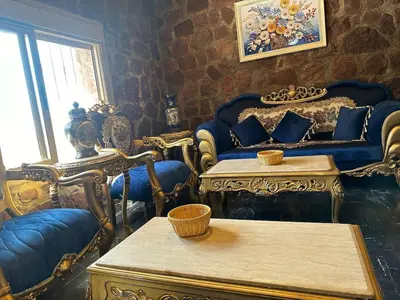 a living room with blue chairs and a table at villa ourika in Marrakech