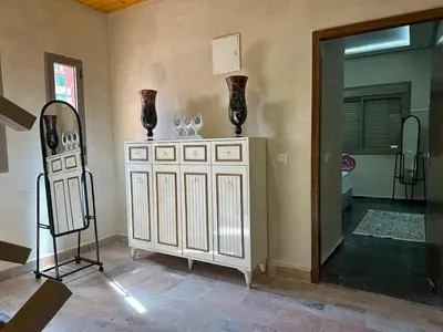 a room with a cabinet with vases on top of it at villa ourika in Marrakech