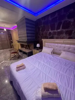 a bedroom with a large white bed and a piano at villa ourika in Marrakech