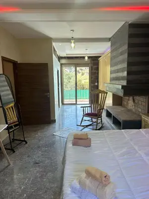 a bedroom with a bed and a fireplace at villa ourika in Marrakech
