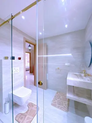 a bathroom with a shower and a toilet and a sink at New! Duplex Annakhil , Calme et proximité centre in Marrakech