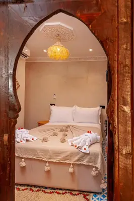 a bedroom with a bed with two towels on it at Riad Akkioui in Marrakech